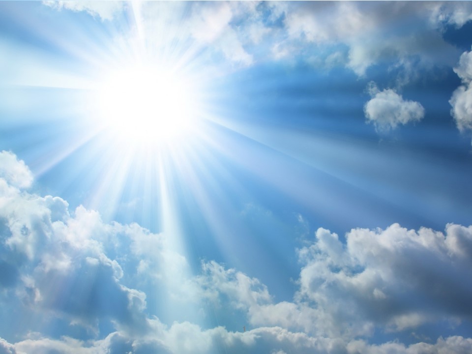The image shows a bright sun shining through white clouds in a blue sky. Sunrays are visible radiating outward from the sun, creating a dramatic sunburst effect through the cloud formations.RetryClaude can make mistakes. Please double-check responses.