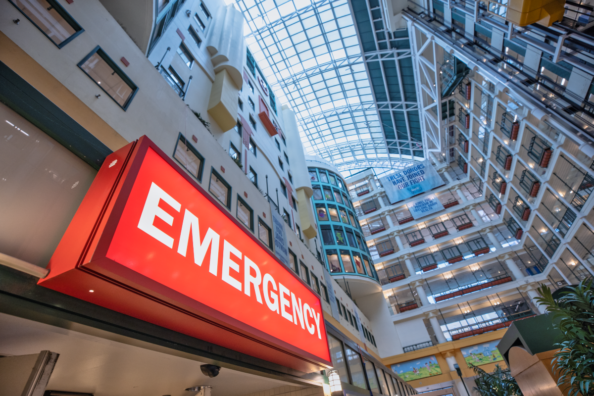 A read sign reads EMERGENCY in the SickKids Atrium