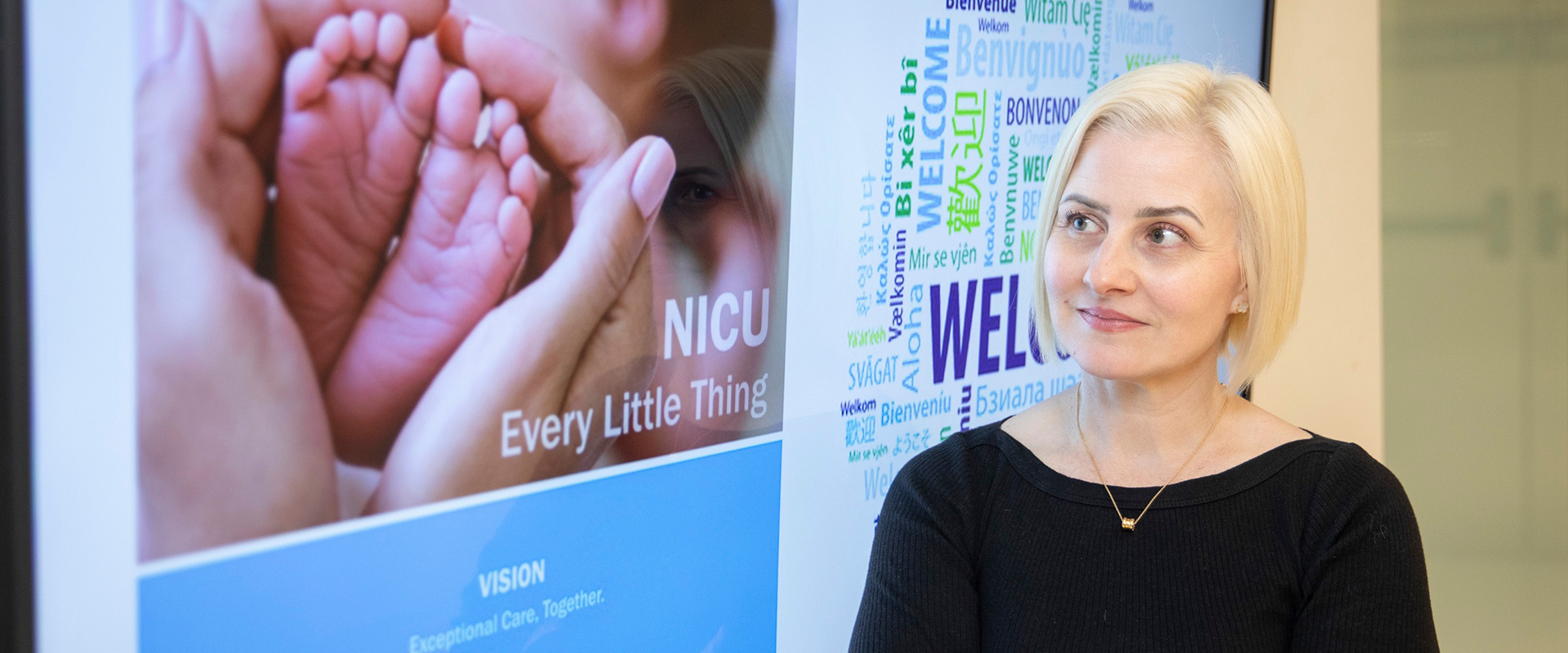 Dr. Angie Lim looking at a sign for the SickKids NICU