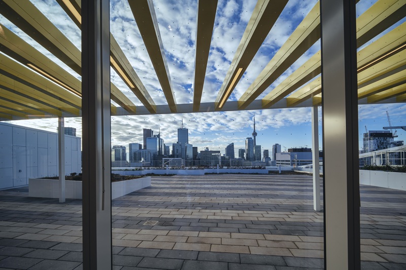 A view of a rooftop deck with the CN tower in the background.