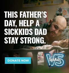 A man smiling and interacting with his child who is lying in a crib. The text reads: This Father's Day, help a SickKids dad stay strong. Donate now.