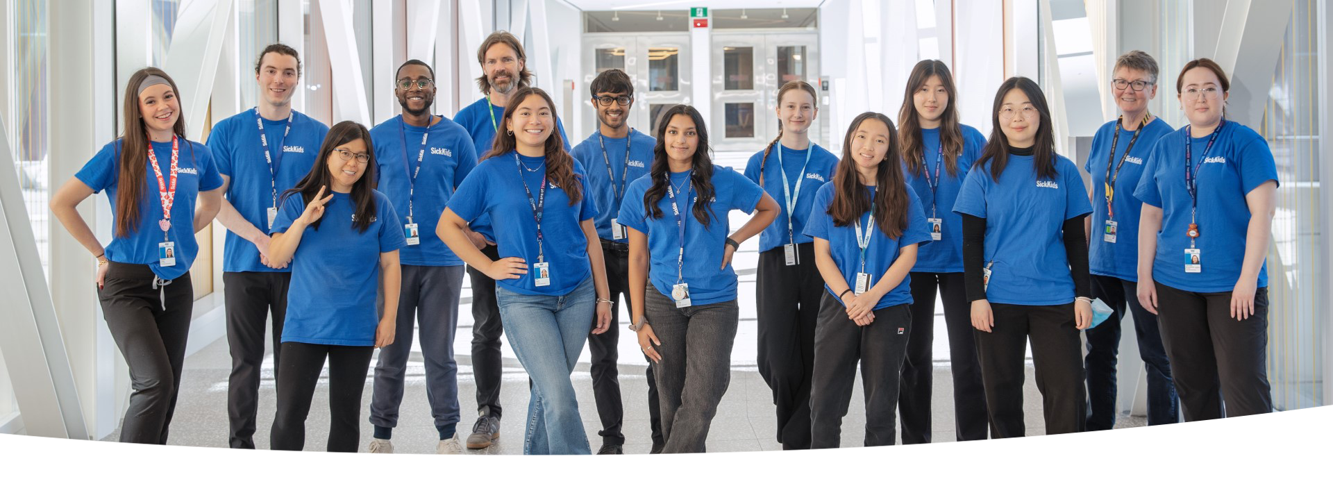 Group of people wearing blue SickKids volunteer t-shirts.