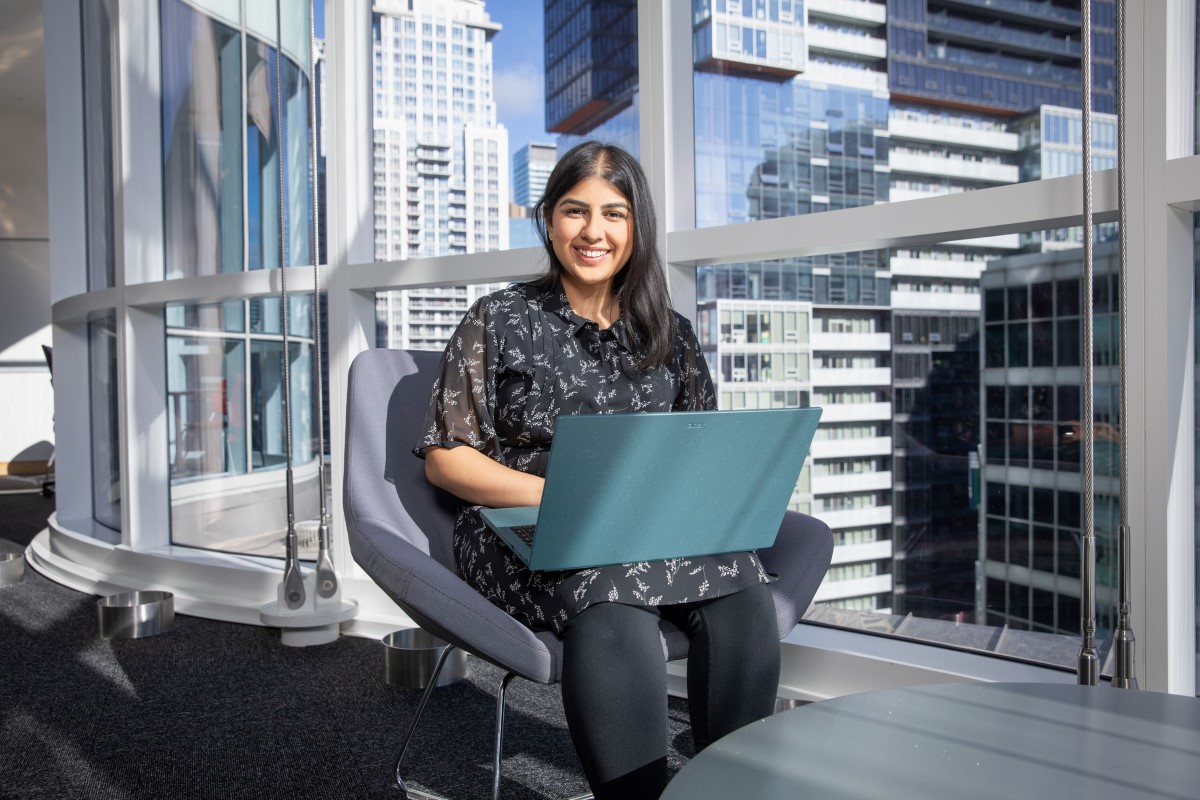 Woman seated with a laptop.