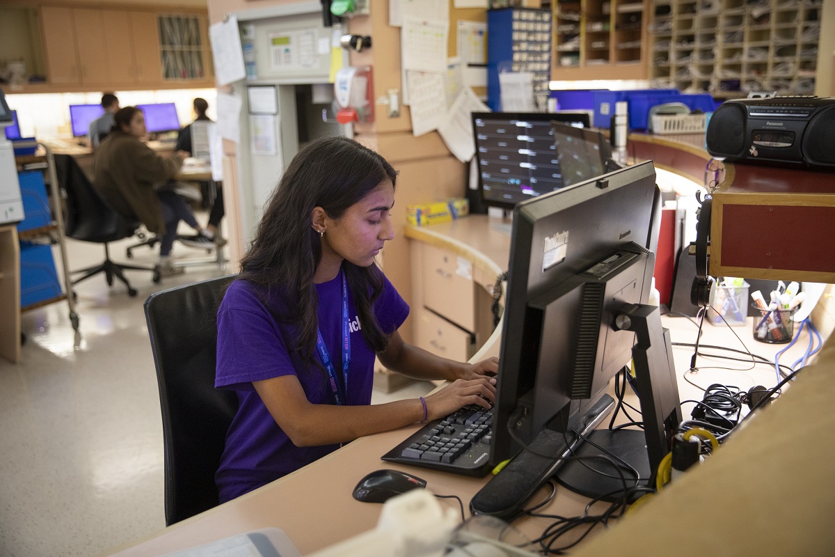 Person seated at a computer. 