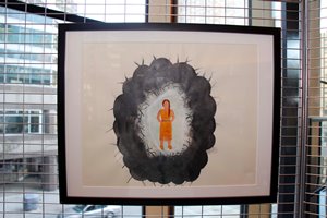 A framed painting depicting a small child surrounded by a dark paint resembling a cloud or hole