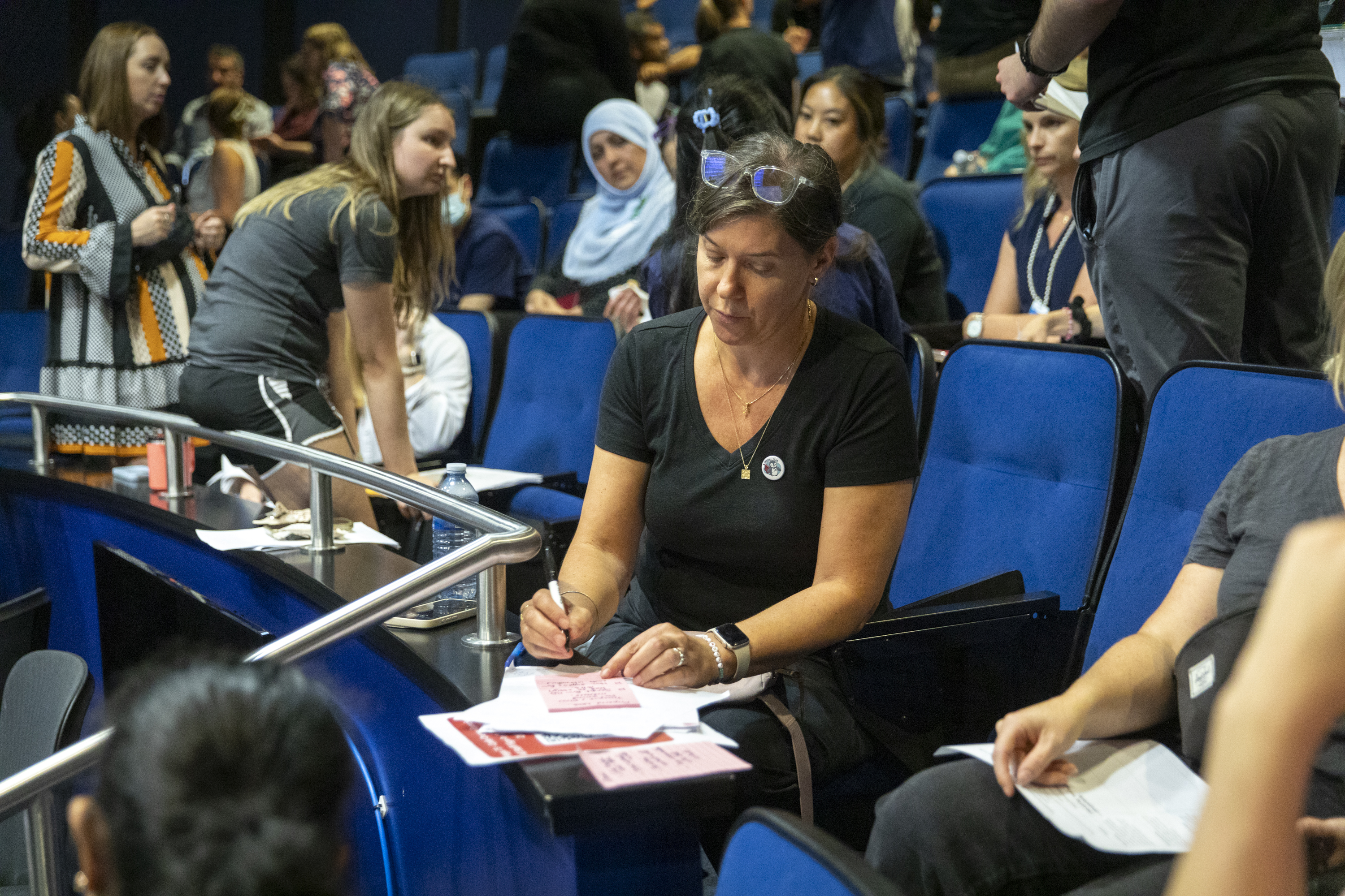  Dr. Suzanne Beno, co-medical director of the Trauma Program, organizes feedback as part of a debrief exercise by writing down her notes on a notepad.