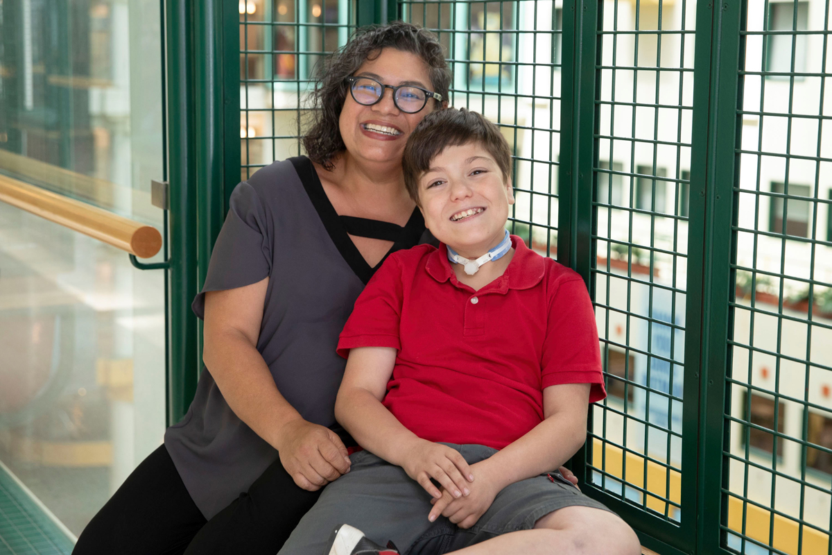 Francine Buchanan and her son, Cristiano, posing together for a photo overlooking the Atrium.