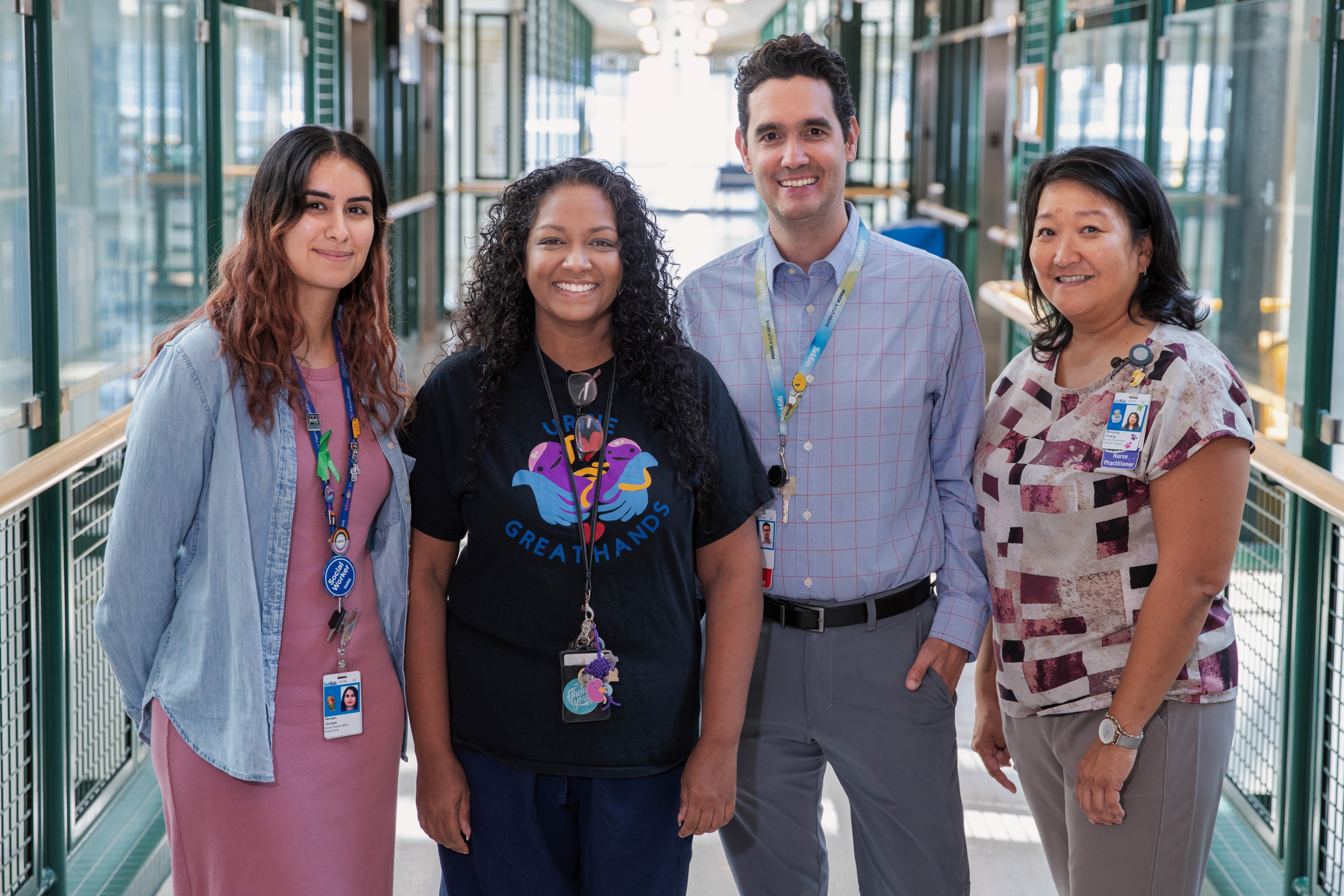 Four of MAGIC clinic team members standing at the elevator hallway