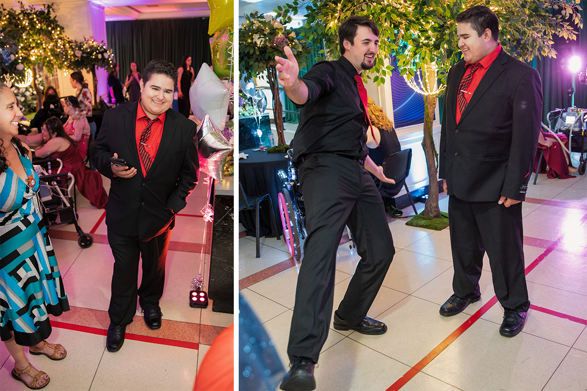 Kyle dressed in a suit, with red dress shirt and striped tie. Sean, dressed in a black dress shirt and red tie, poses for a photo with Kyle.