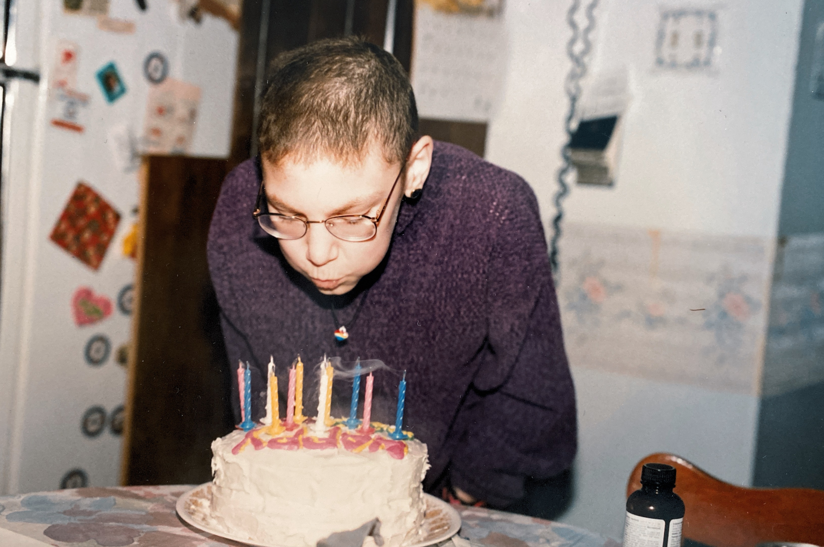 Natalie, 12, blows out the candles on a birthday cake.