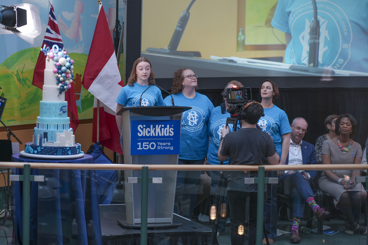 Lizzy Leonard speaking at the podium on the Atrium stage. 
