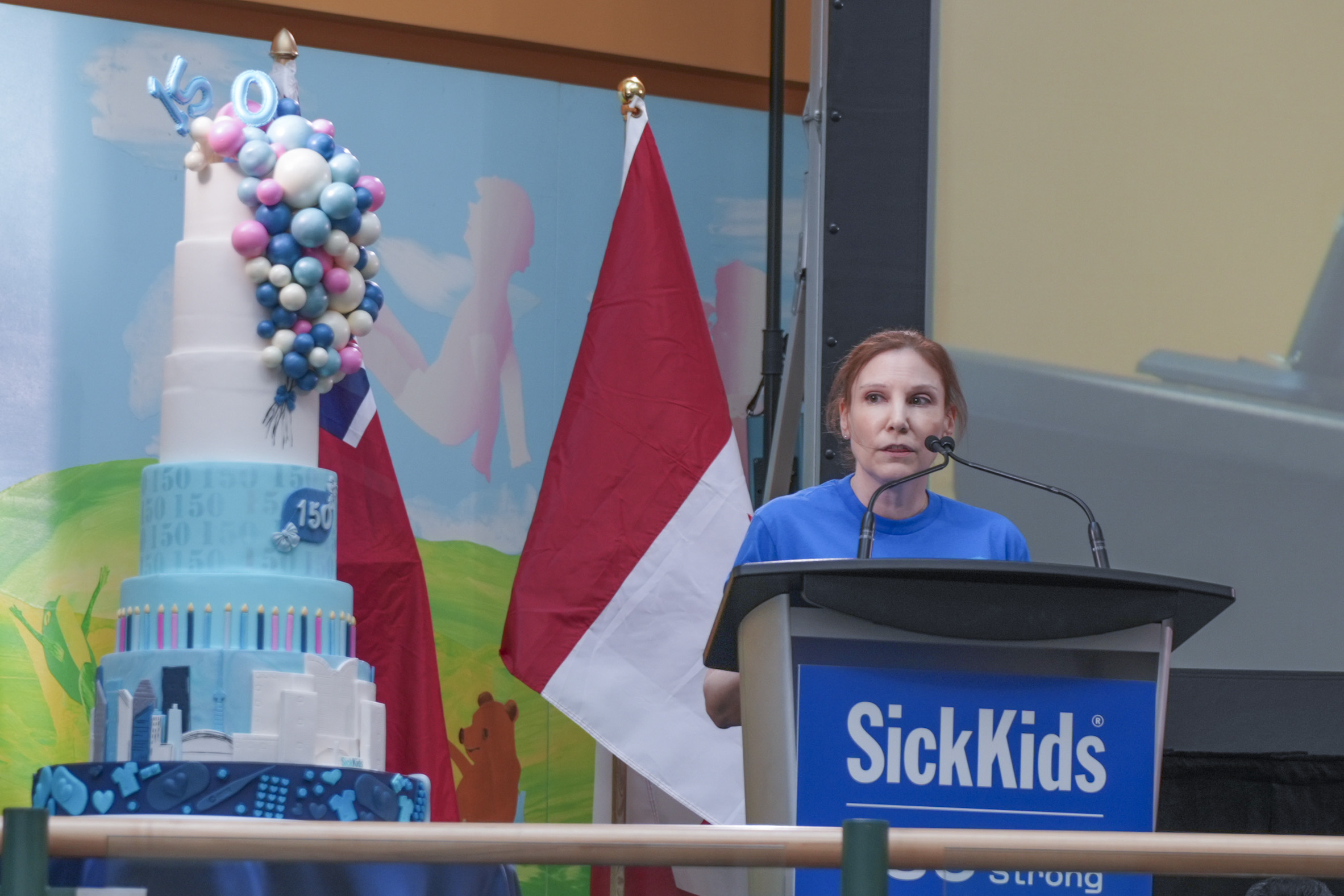 Natalie Wilson speaking at the podium on the Atrium stage